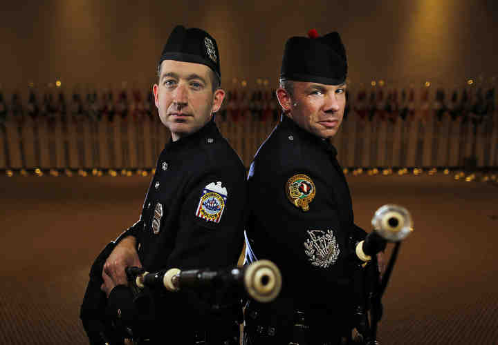 Nick Siers (left) and Martin Kestne of The Columbus Police and Fire Pipes and Drums poses for a photo at the Columbus Police Academy.    (Kyle Robertson / The Columbus Dispatch)